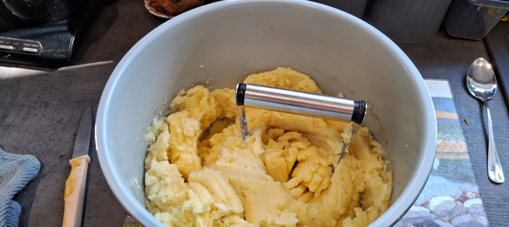 potatoes being mashed in the air fryer