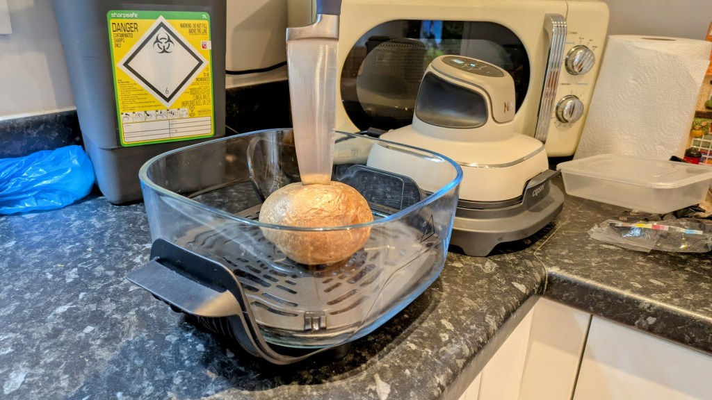 Testing the doneness of a jacket potato with a knife