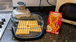 4 potato waffles in a air fryer waiting to be cooked