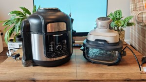 The Ninja Foodi Max Multi-Cooker on a coffee table next to the Ninja Crispi