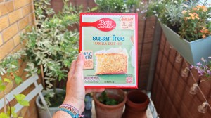 Betty Crocker Sugar-free vanilla cake in its box being held up