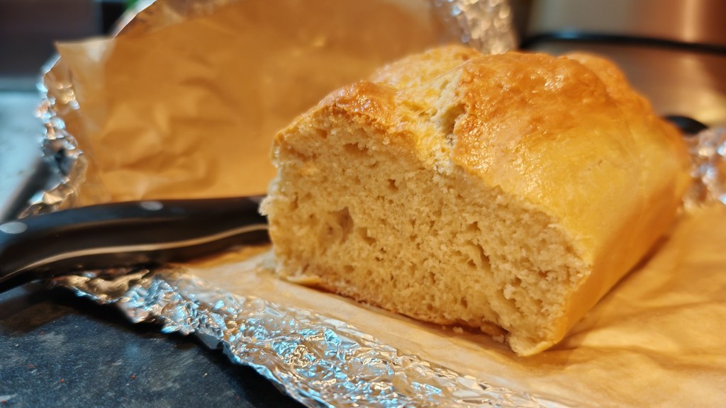 One brioche loaf sliced so you can see the airy texture inside
