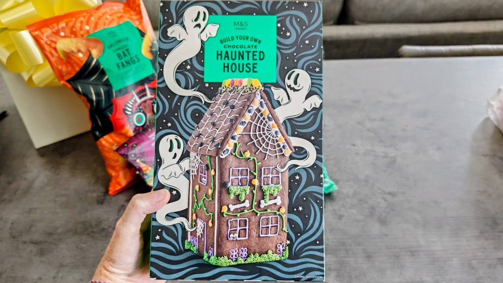 The M&S Haunted House in its box being held in a kitchen