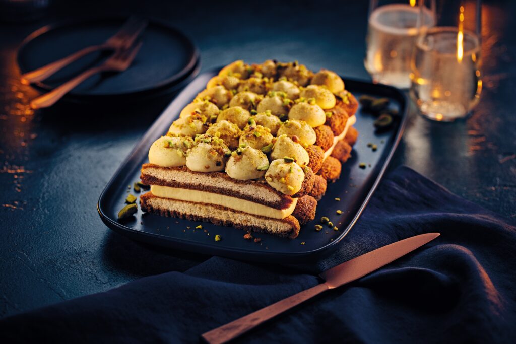 The Specially Selected Centerpiece Pistachio Tiramisu sliced so you can see the layers