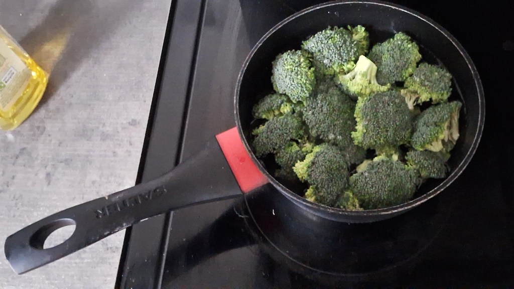 Broccoli florets in a saucepan