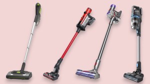 Four cordless stick vacuums on a pink background