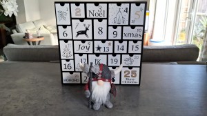 Viking gonk in front of a wooden Advent calendar