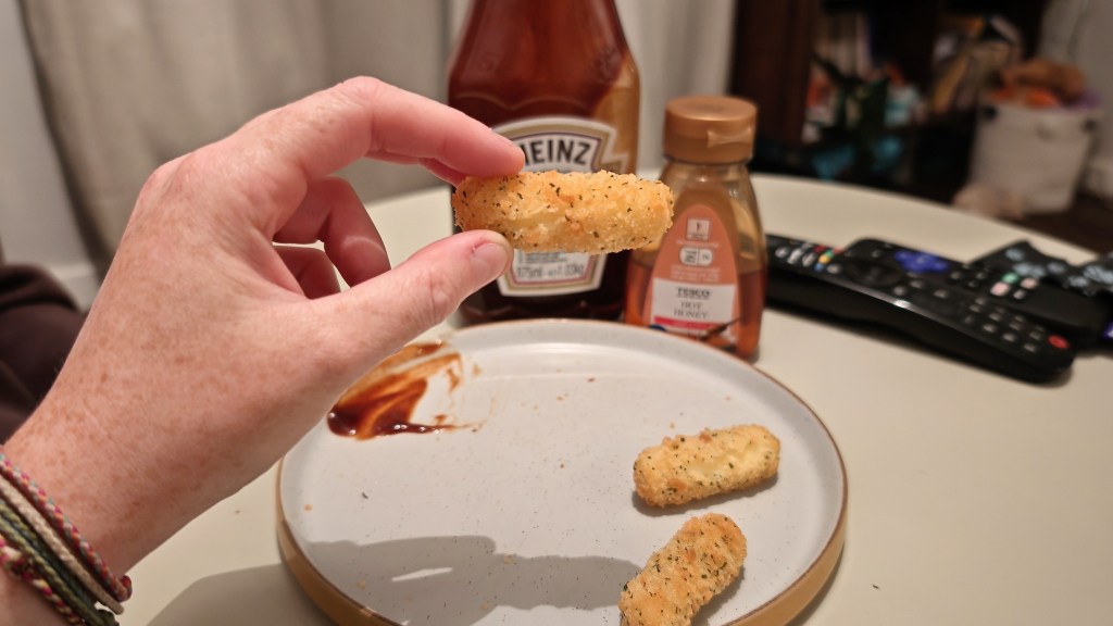 Holding an air fried mozzarella stick